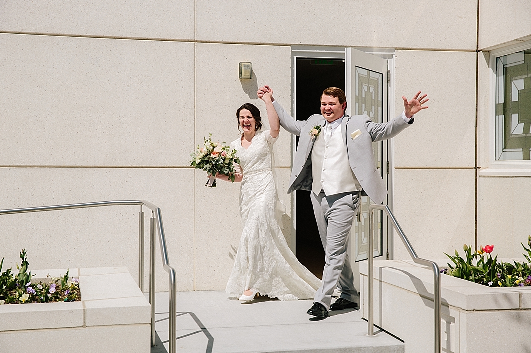 bride and groom walking out of LDS temple after romantic Idaho Falls wedding
