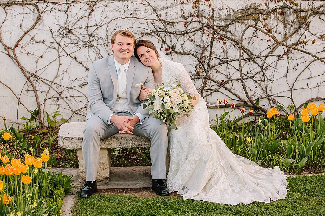 bride and groom sitting on bench in Idaho falls after LDS temple wedding