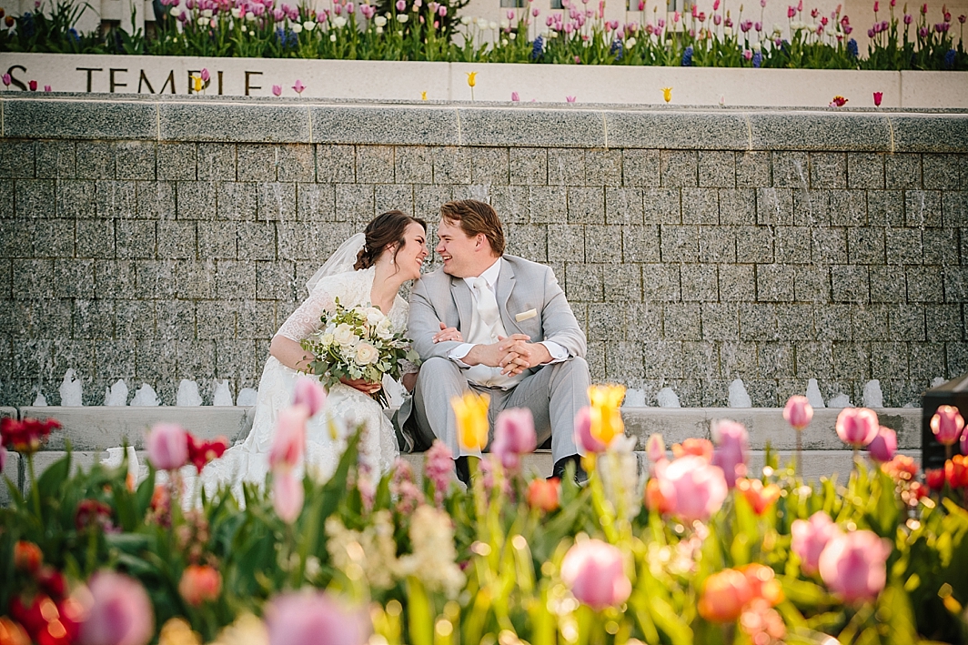 bride and groom sitting down during outdoor bridal portraits