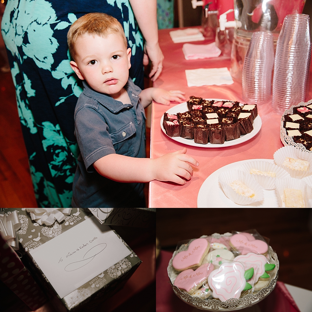 young boy looking at camera standing at dessert table after romantic idaho falls wedding ceremony