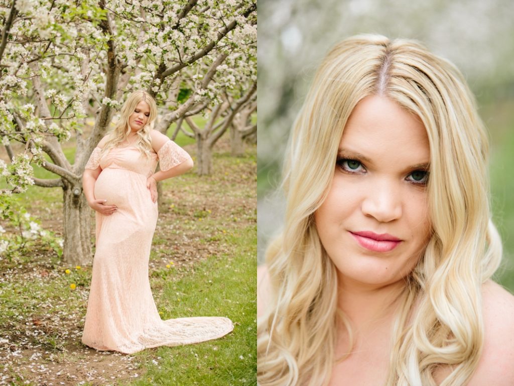 woman standing with hand on belly during spring apple blossoms maternity photos