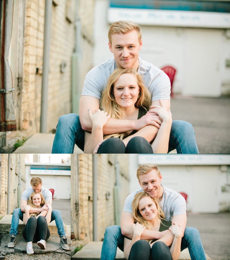 man hugging woman from behind while smiling during engagements