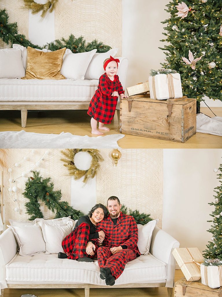 family sitting together wearing matching pajamas in front of christmas tree 
