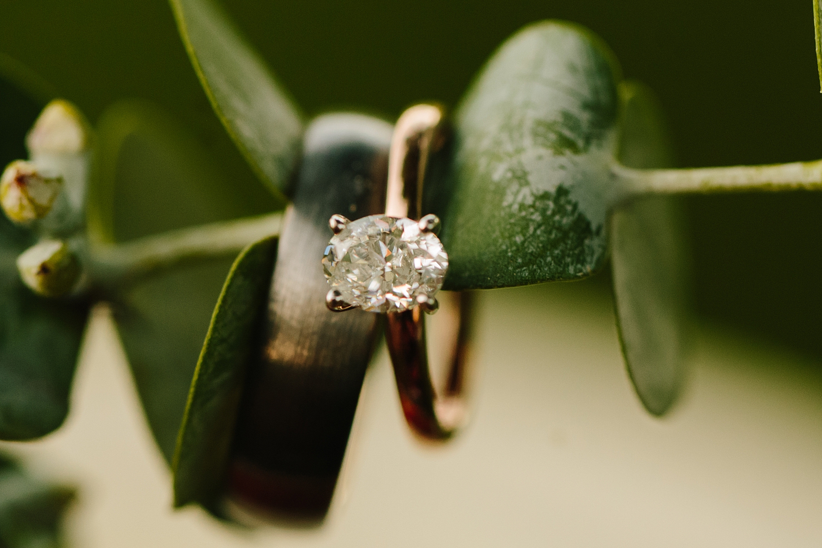 engagement ring hanging on a eucalyptus leaf in a wedding bouquet