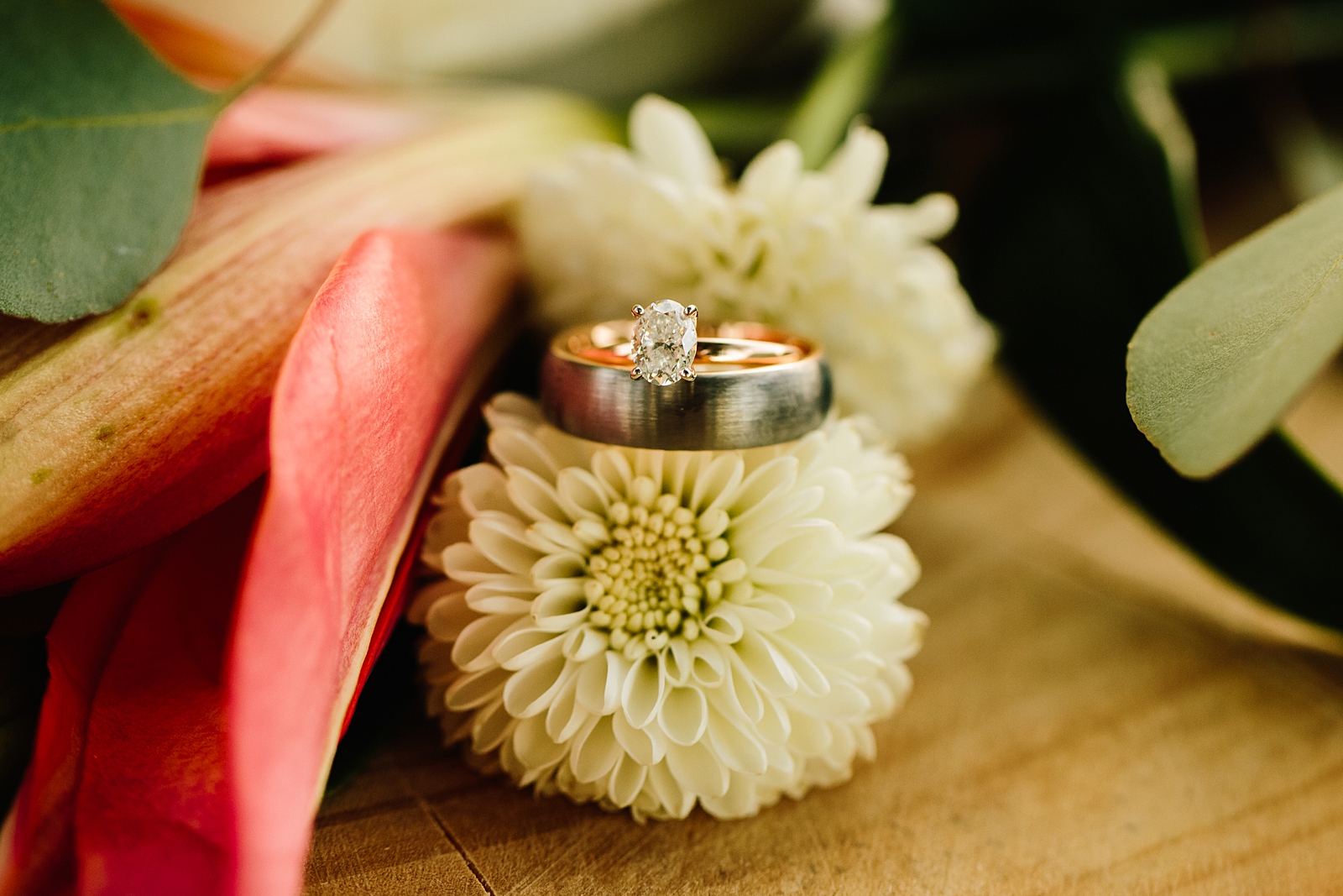 bride and grooms wedding rings sitting on top of a flower captured by Pocatello wedding photographer