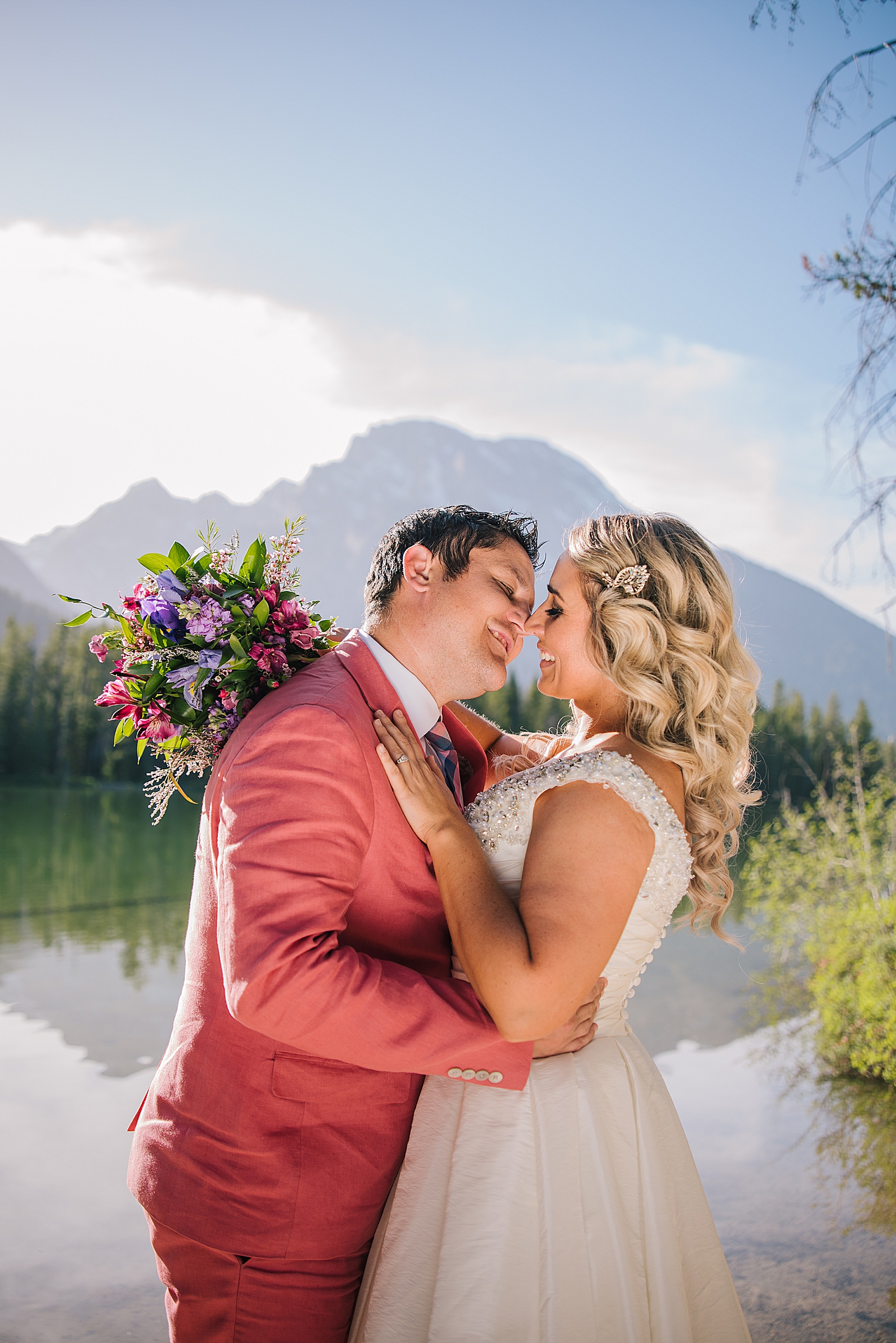 bride and groom leaning in to kiss each other for the Grand Teton wedding with Jackson Hole wedding photographer