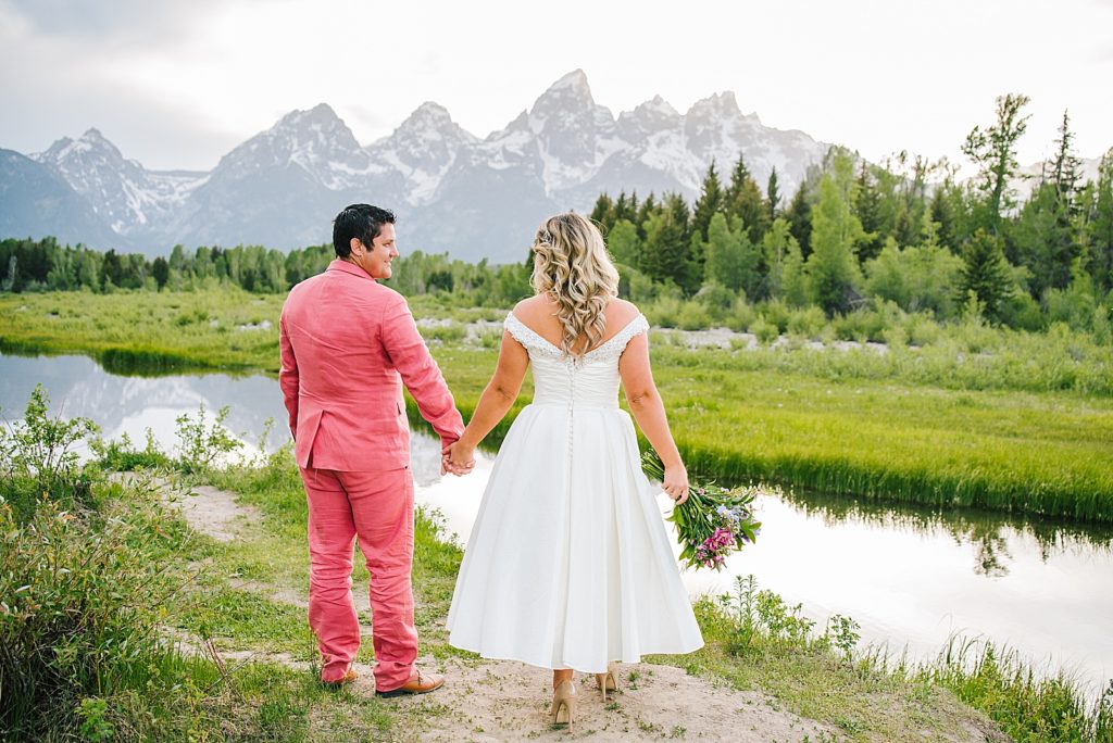 Jackson Hole wedding photographer captures couple walking through Grand Teton National Park after budget friendly Jackson Hole wedding