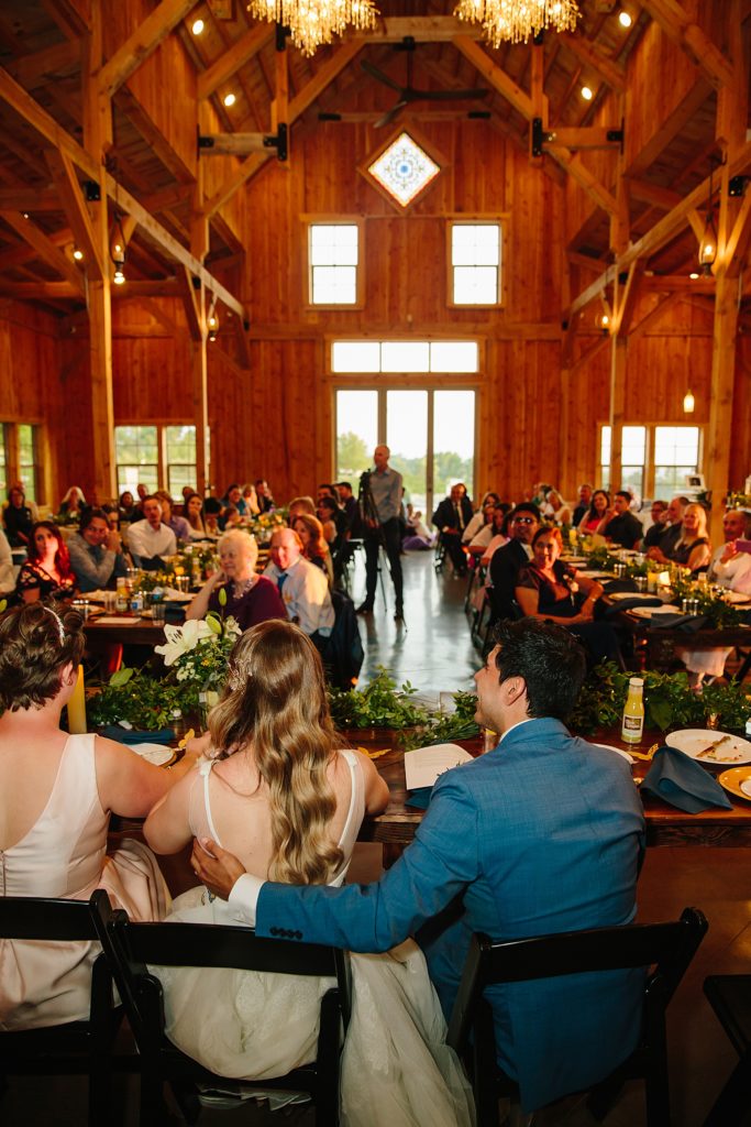 Jackson Hole wedding photographer captures bride and groom sitting during reception