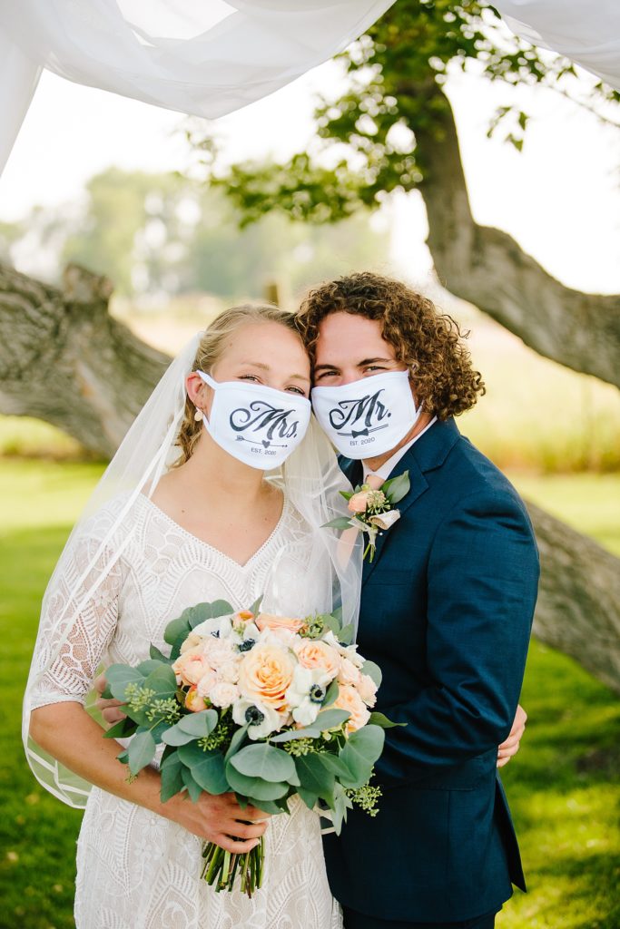 bride and groom in their Mr and Mrs masks