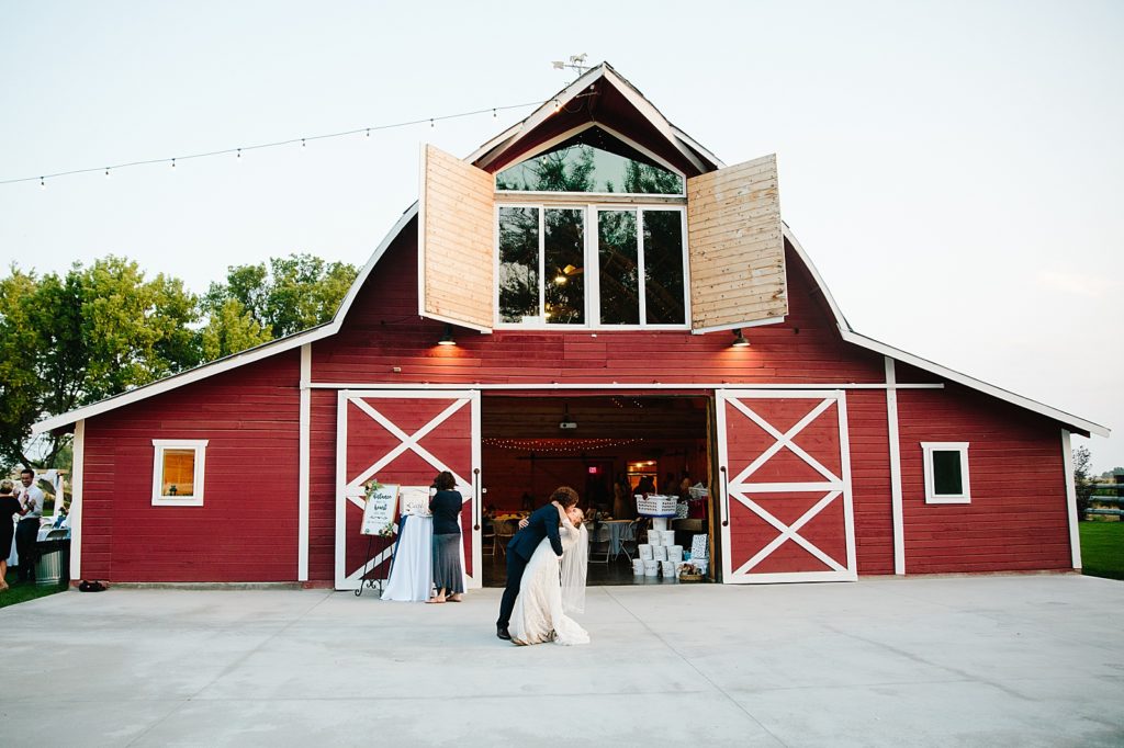 red bard Idaho wedding venue with bride and groom dancing together for their outdoor wedding