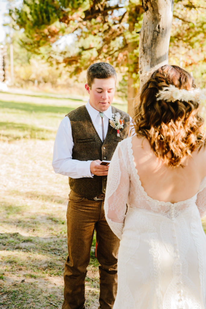 groom reading vows to bride during wedding ceremony