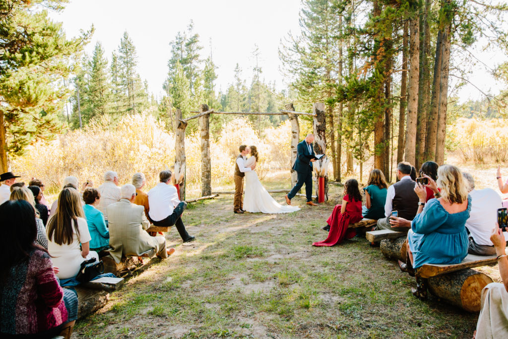 bride and groom kissing as husband and wife at eagle ridge ranch wedding ceremony