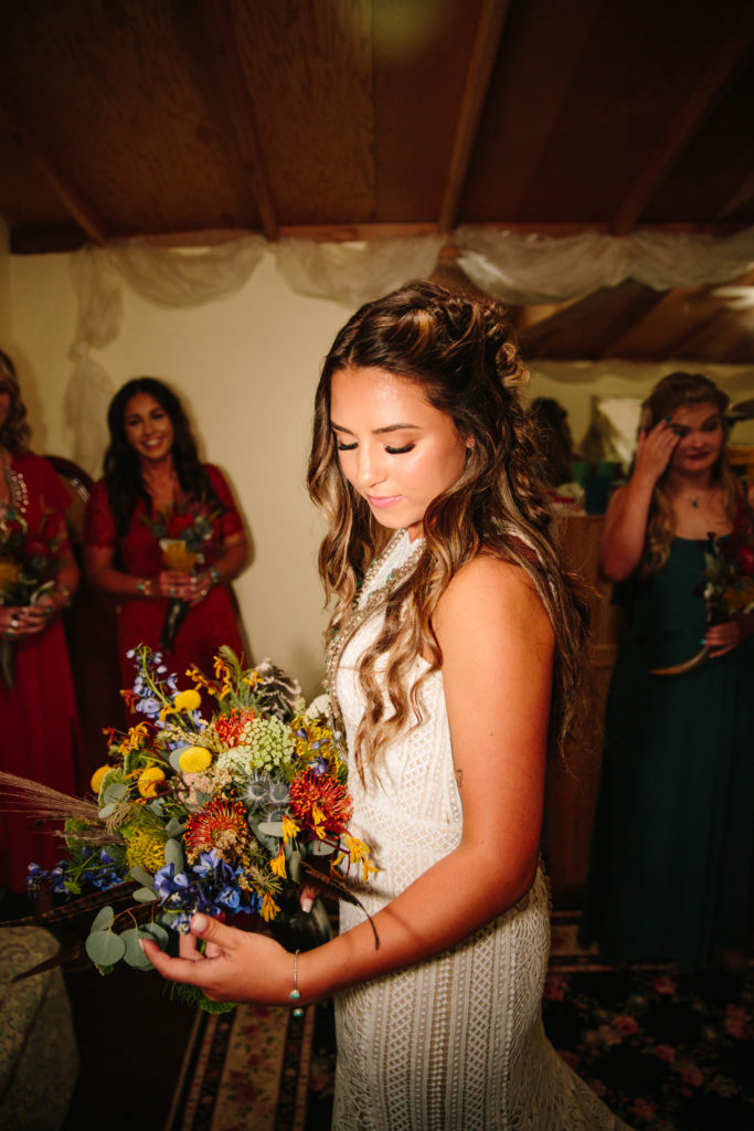 bride looking at bouquet on wedding day