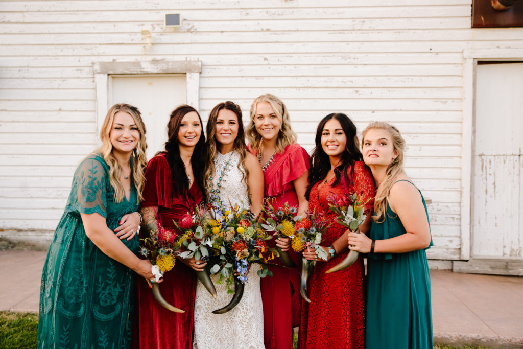 bridal party holding bouquets in cow horns for western island park wedding day
