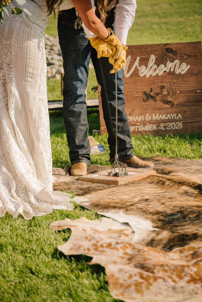 bride and groom branding wood together to unify marriage