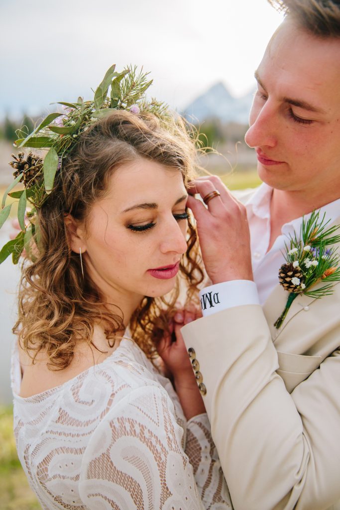 groom brushing his brides hair behind her ear on their Grand Teton wedding day