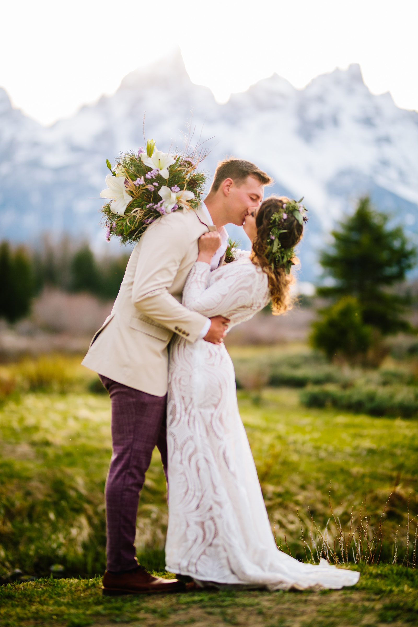 bride and groom kiss at their outdoor wedding ceremony in the Tetons 