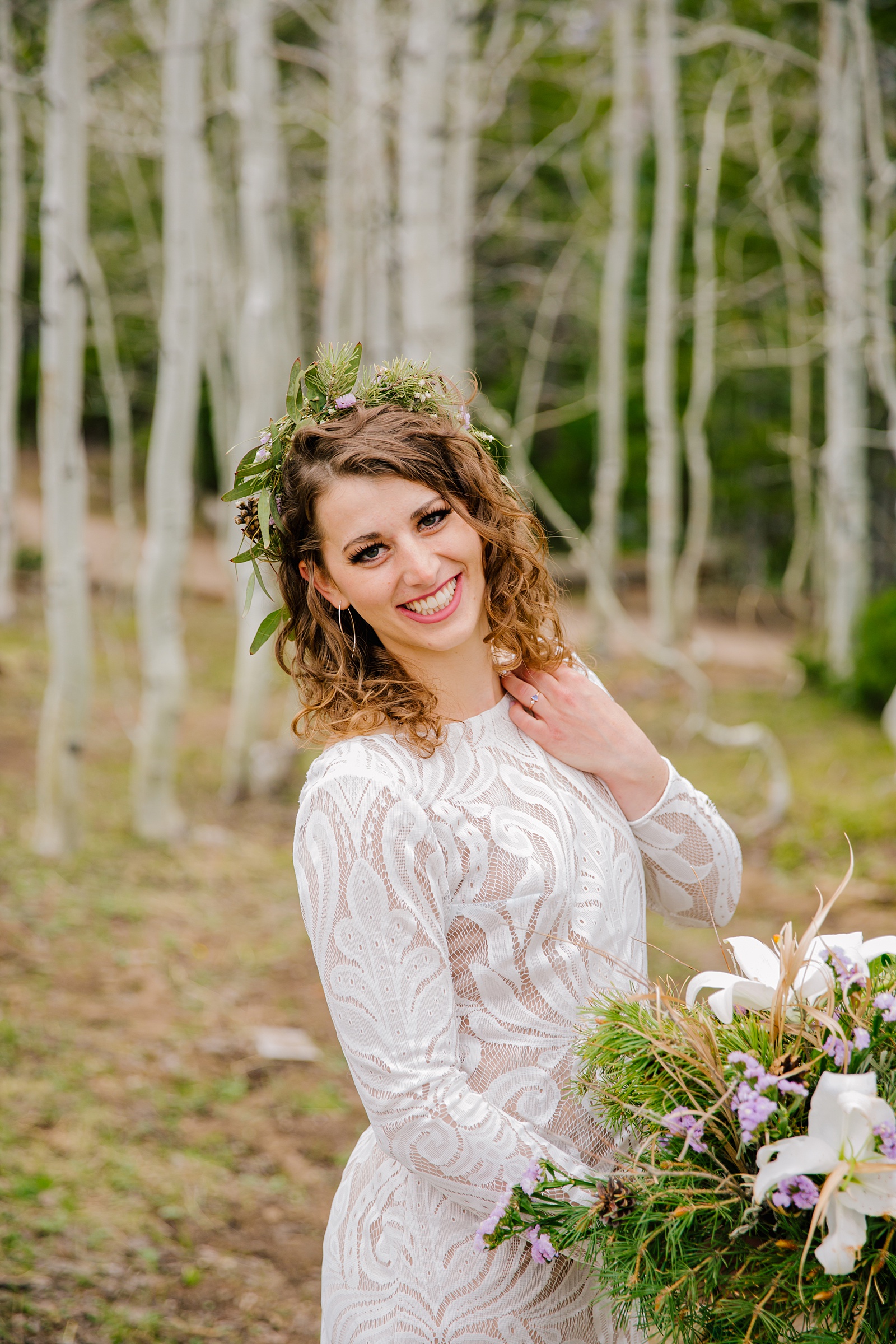 bride posing in the woods for her Grand Teton wedding in the forest 