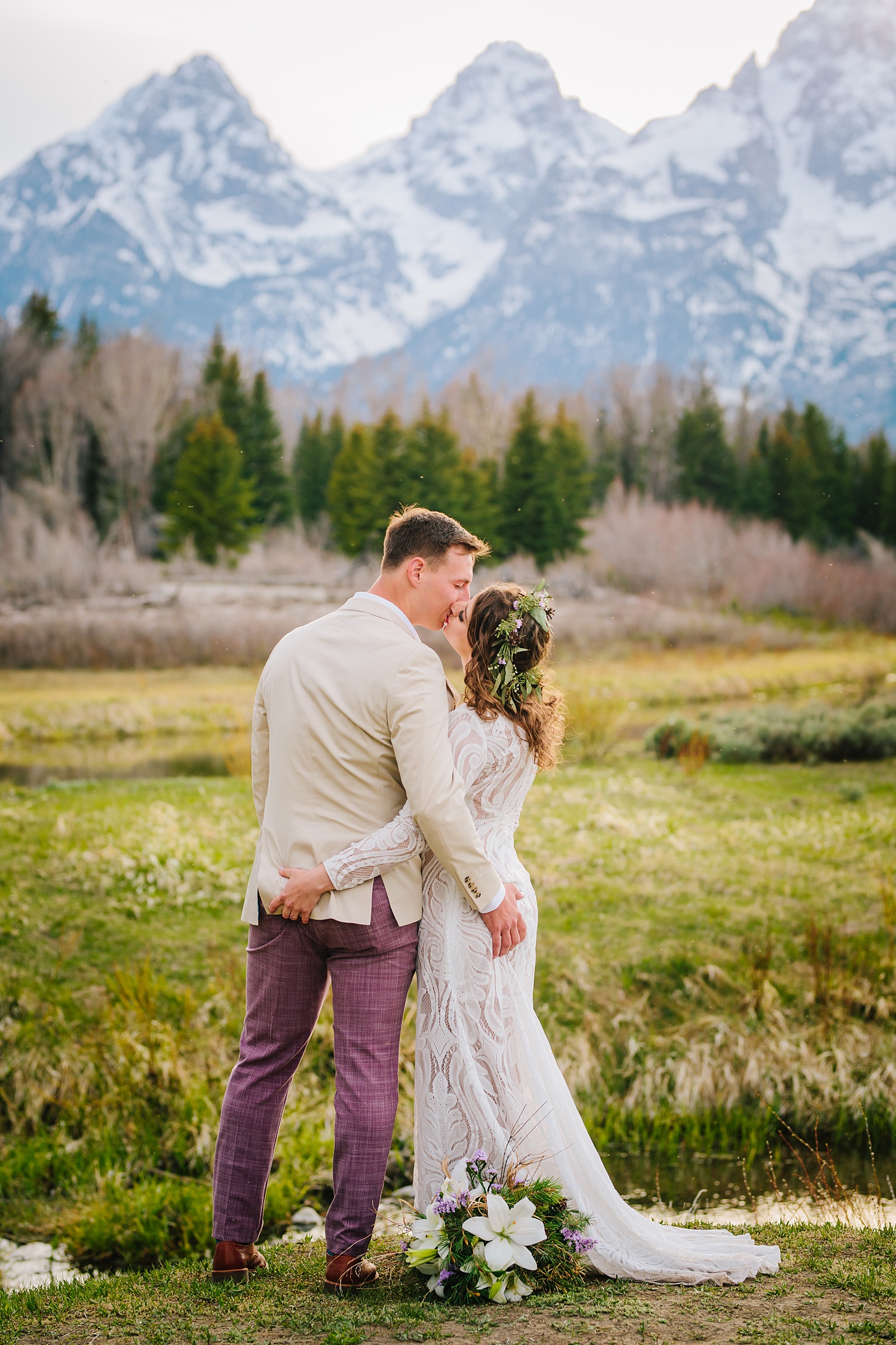 bride and groom loooking in the distance at the mountains together 