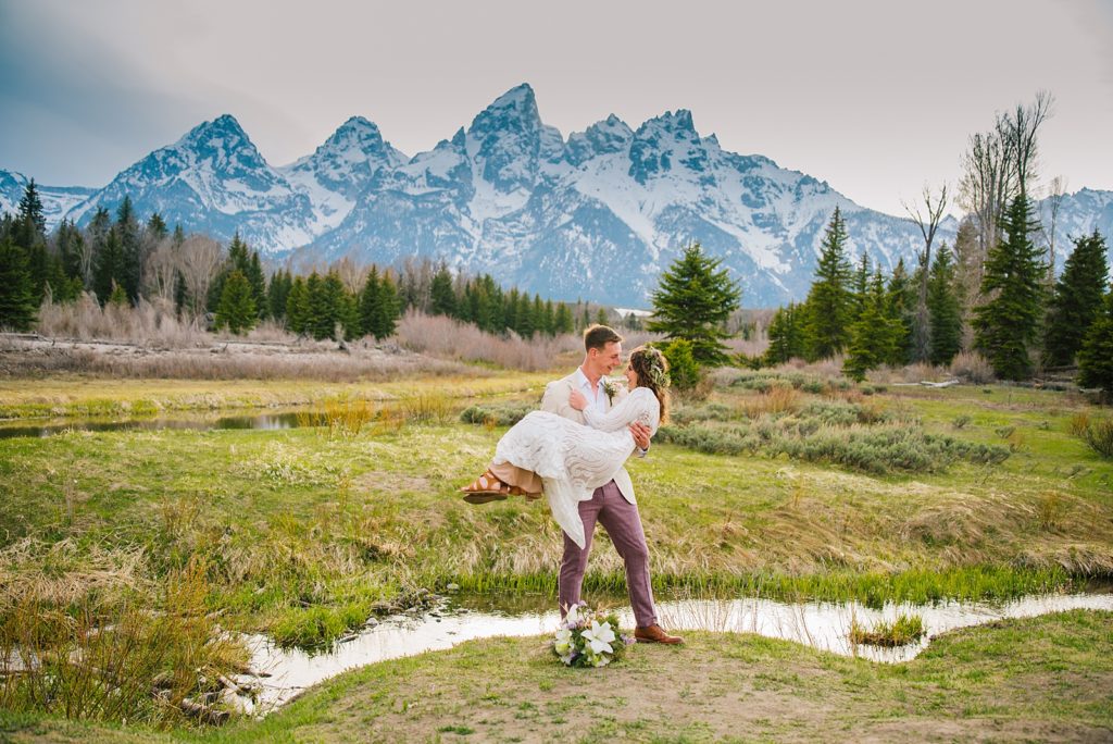 Jackson Hole wedding photographer captures bride and groom celebrating in grand teton national park