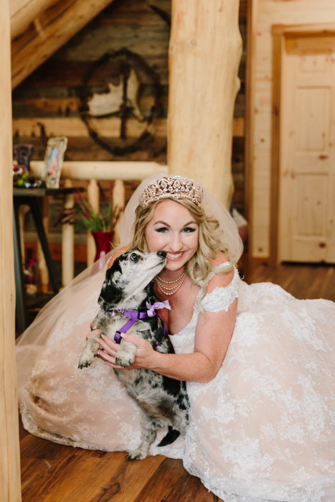 bride holding her weiner dog side kick, missy