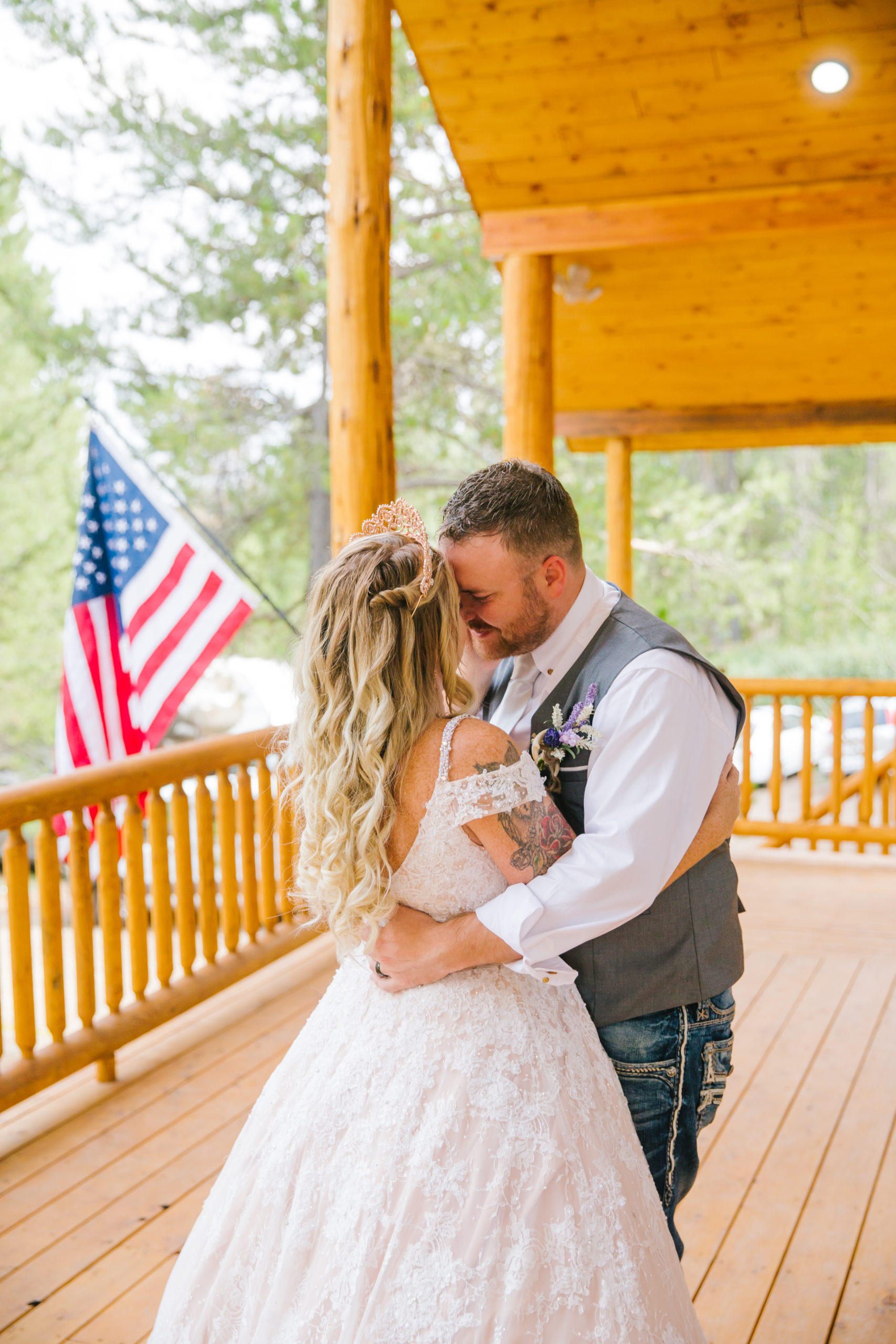 bride and groom dancing on a porch of their Pocatello wedding venue and kissing 