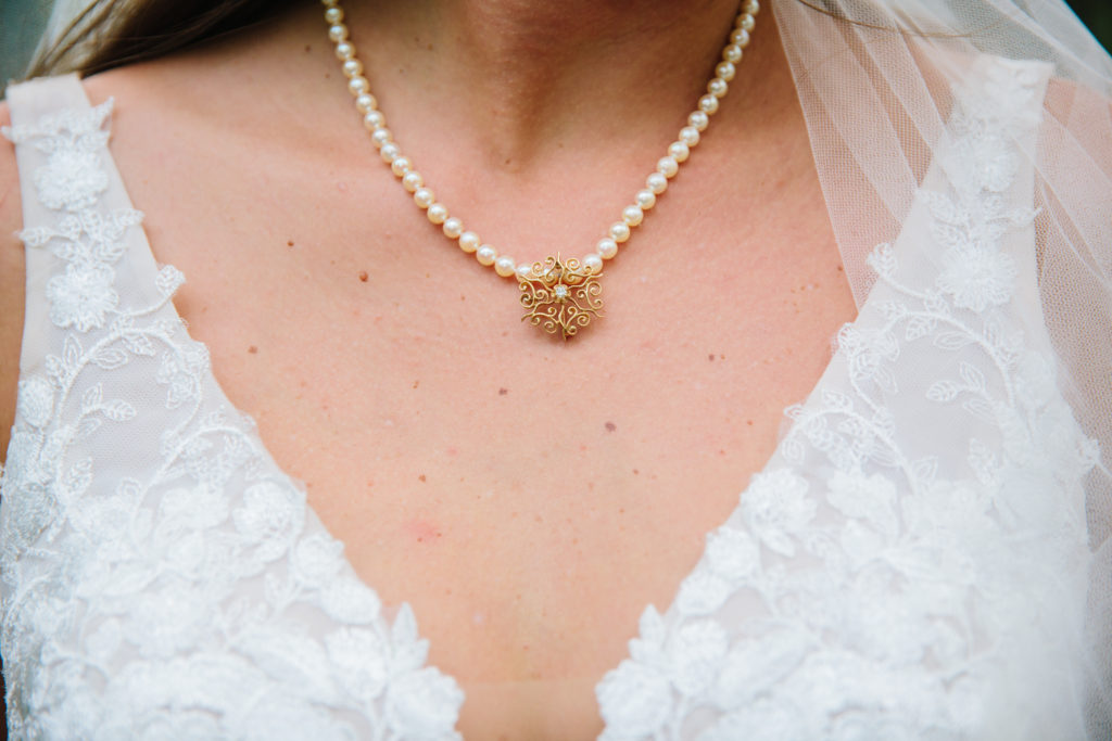 bride wearing family necklace during spring jackson hole bridals