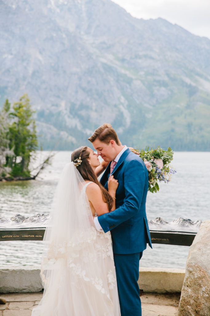 bride and groom hugging at overlook in tetons national park