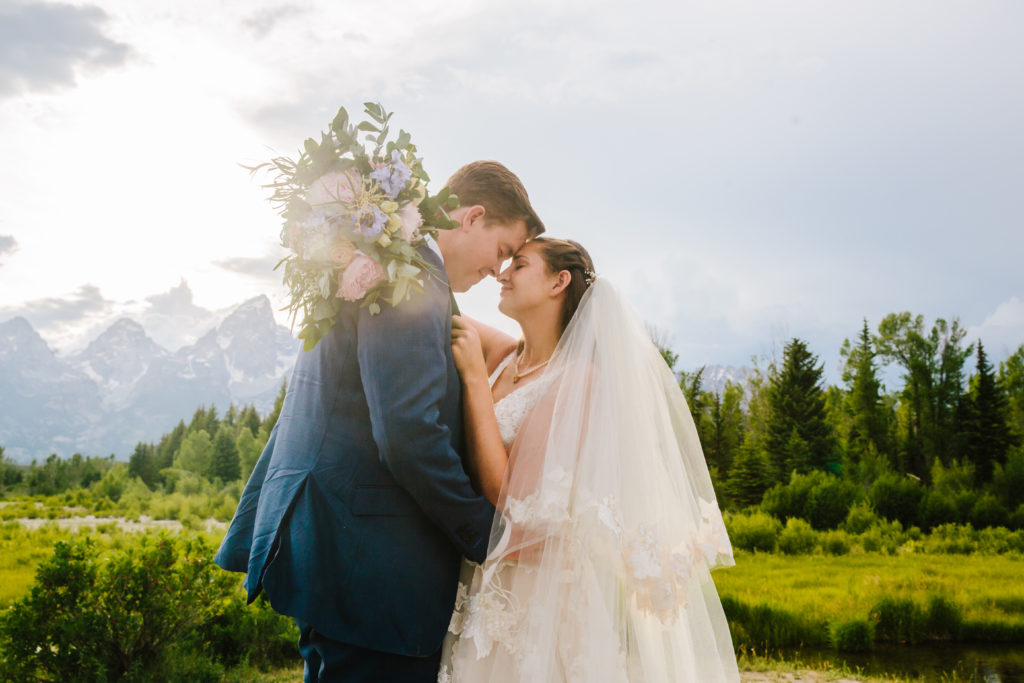 Grand Teton bridals with bride and groom emracing as the sun shines down on them