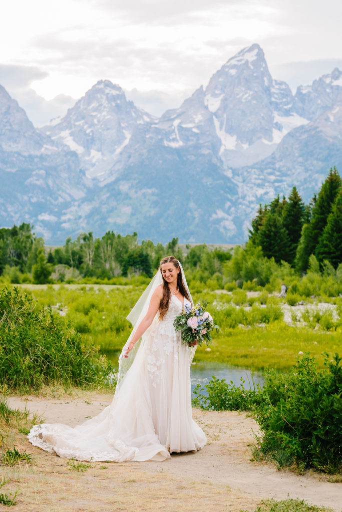 Jackson Hole wedding photographer captures bride in mountains moving around in dress