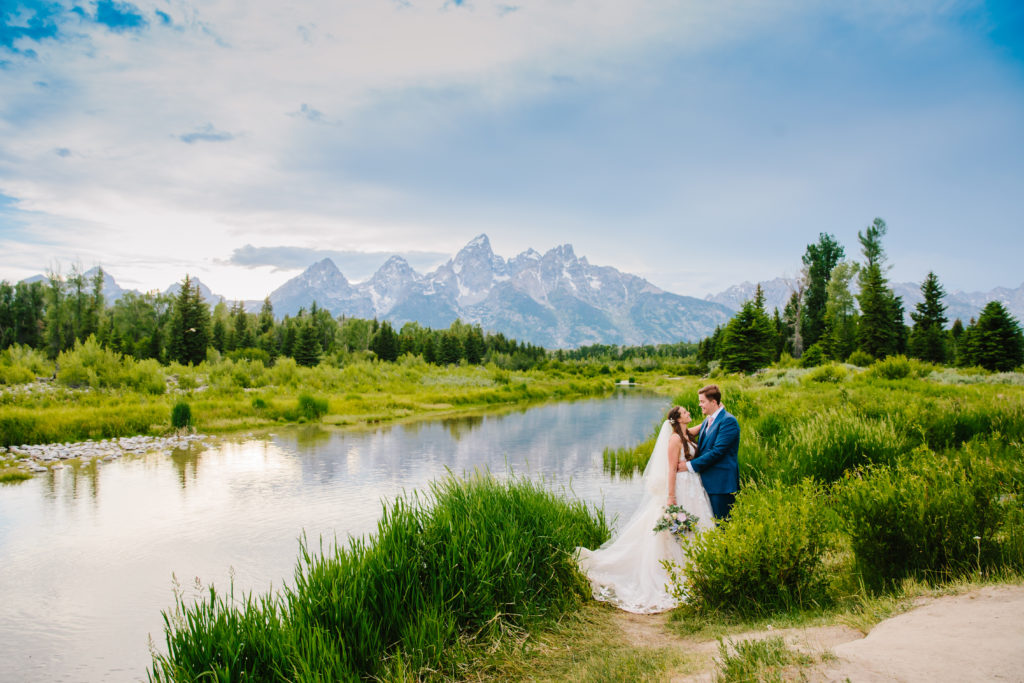 Jackson Hole wedding photographer captures bride and groom embracing during bridals outdoors