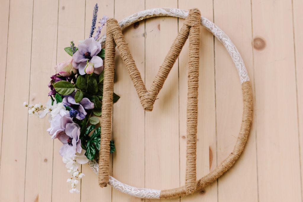 wooden wedding detail decor with last name and floral