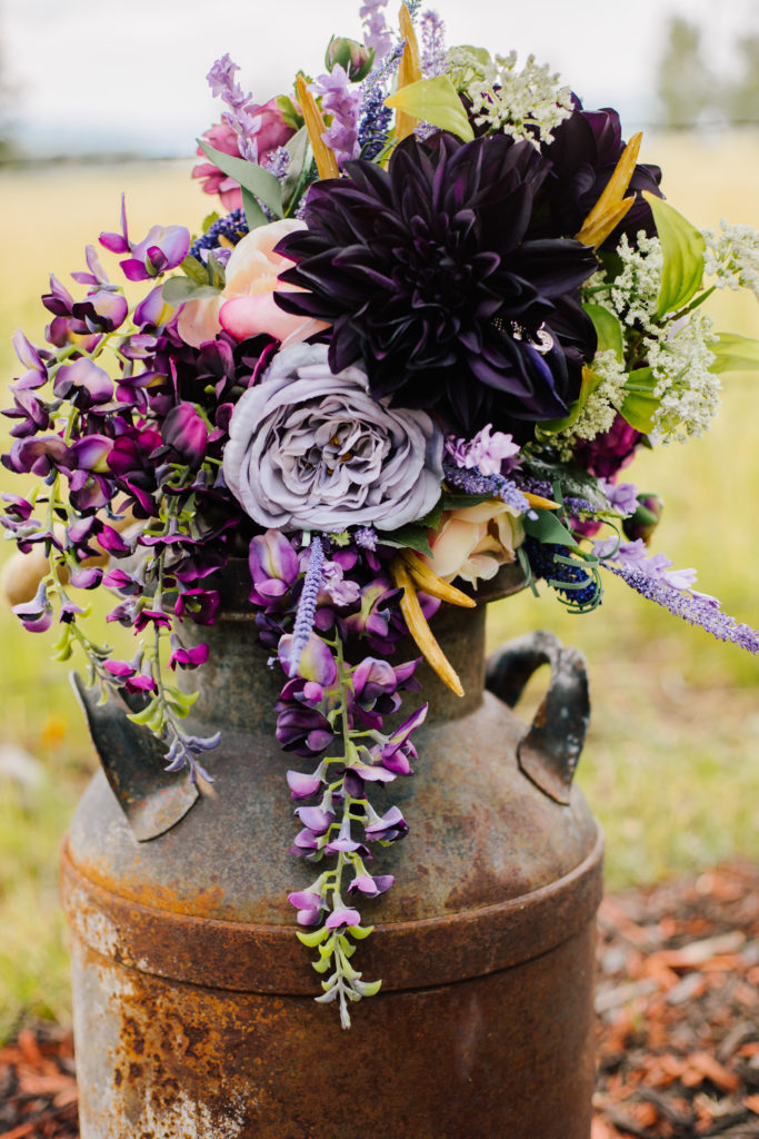 purple wedding florals in an old pot for a rustic chic wedding day