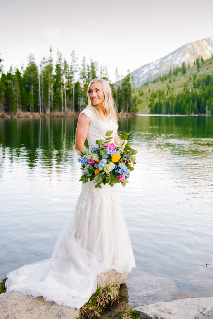 bride standing on a rock at string lake in Grand Teton National Park