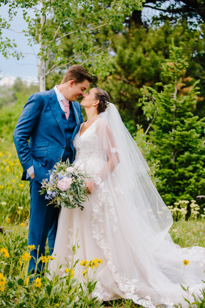 bride and groom in wedding dress and blue suit