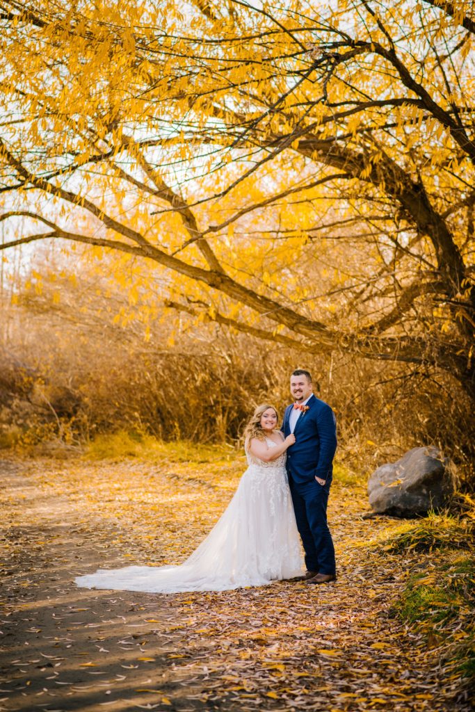 Jackson Hole wedding photographer captures bride and groom embracing in forest