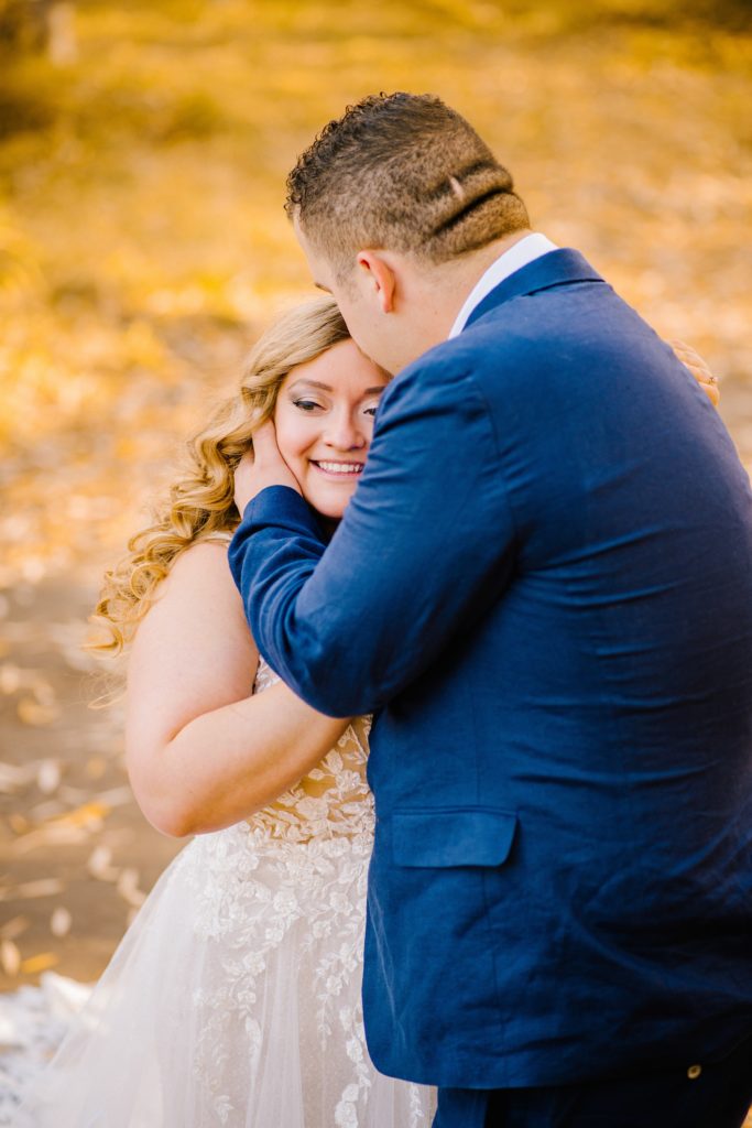 Jackson Hole wedding photographer captures groom kissing bride's forehead