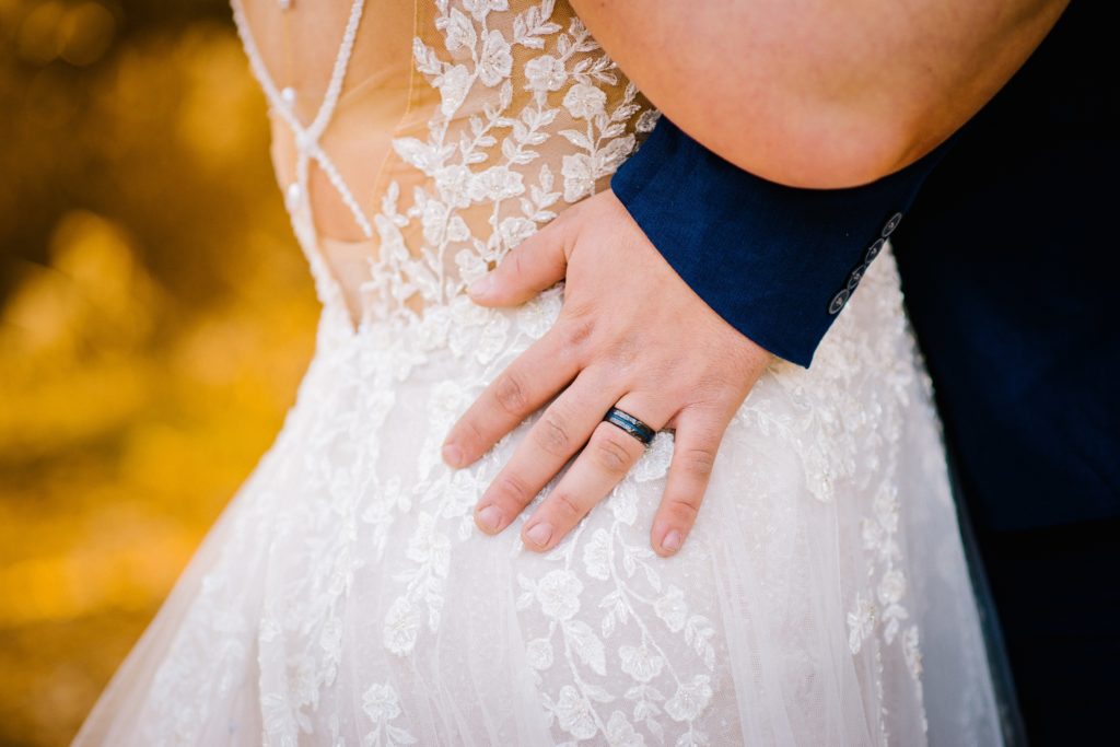 Jackson Hole wedding photographer captures groom hugging bride's waist