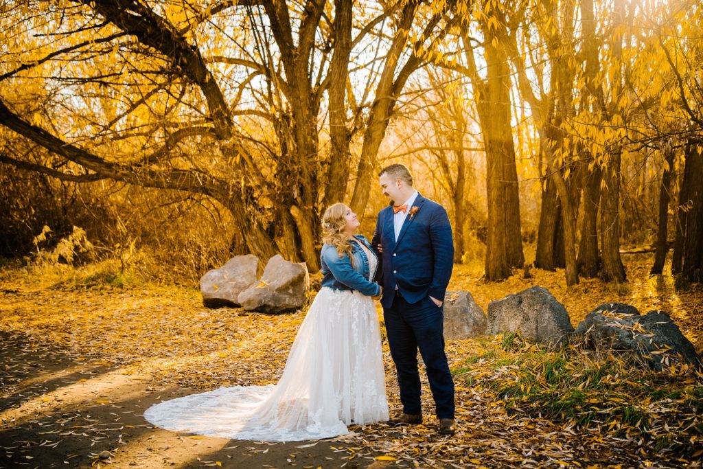 Jackson Hole wedding photographer captures bride and groom standing together wearing wedding attire