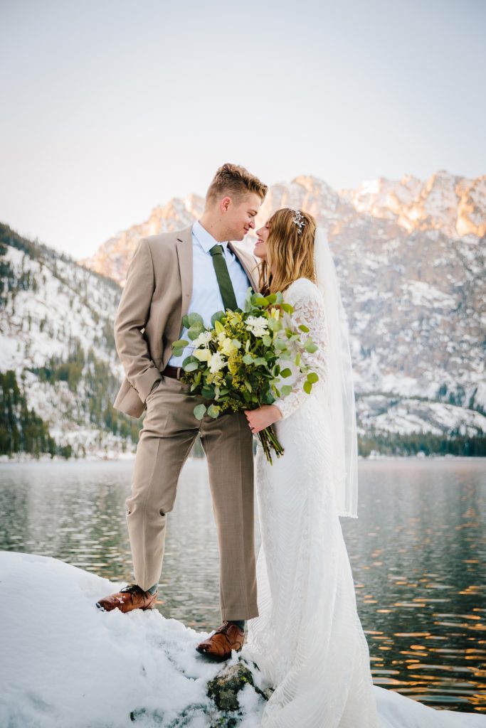 Jenny Lake winter wedding Bride and groom on rock