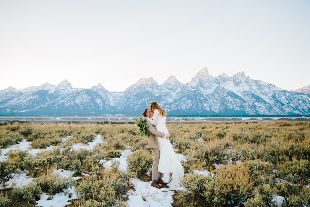 Jackson Hole wedding photographer captures groom lifting bride