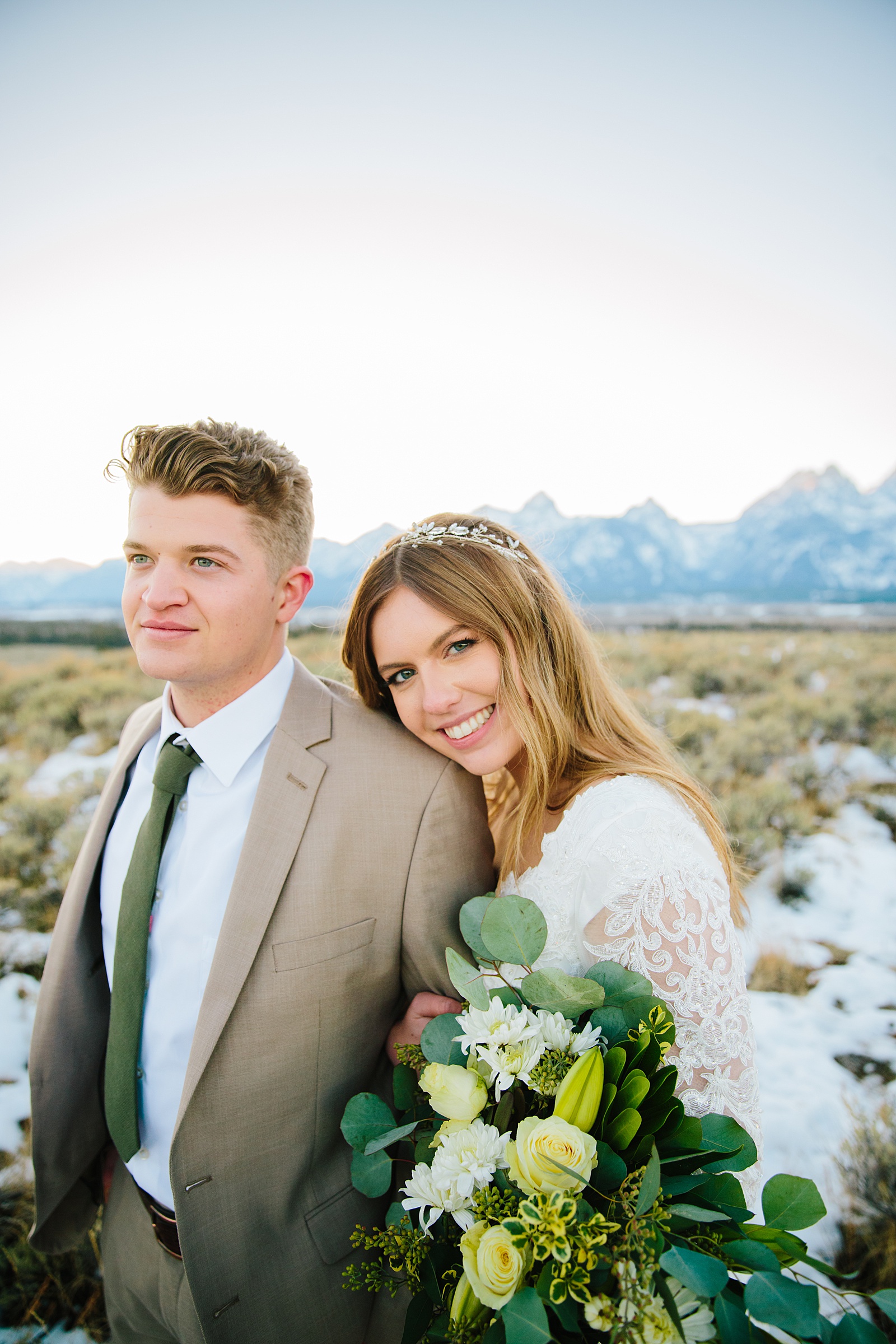 bride and groom standing in a field in Pocatello Idaho together for their outdoor winter wedding photos