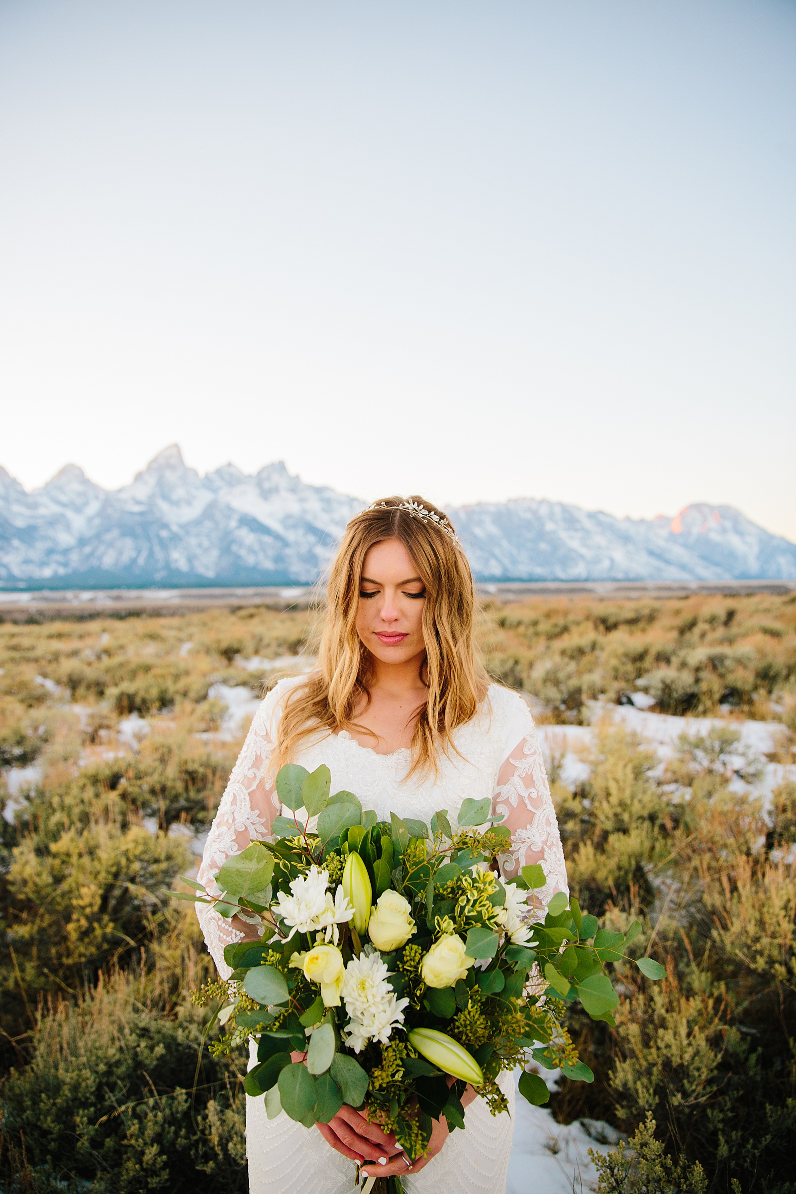 outdoor winter wedding photos of bride holding her white wedding bouquet that she got from vendors for a Pocatello wedding florist