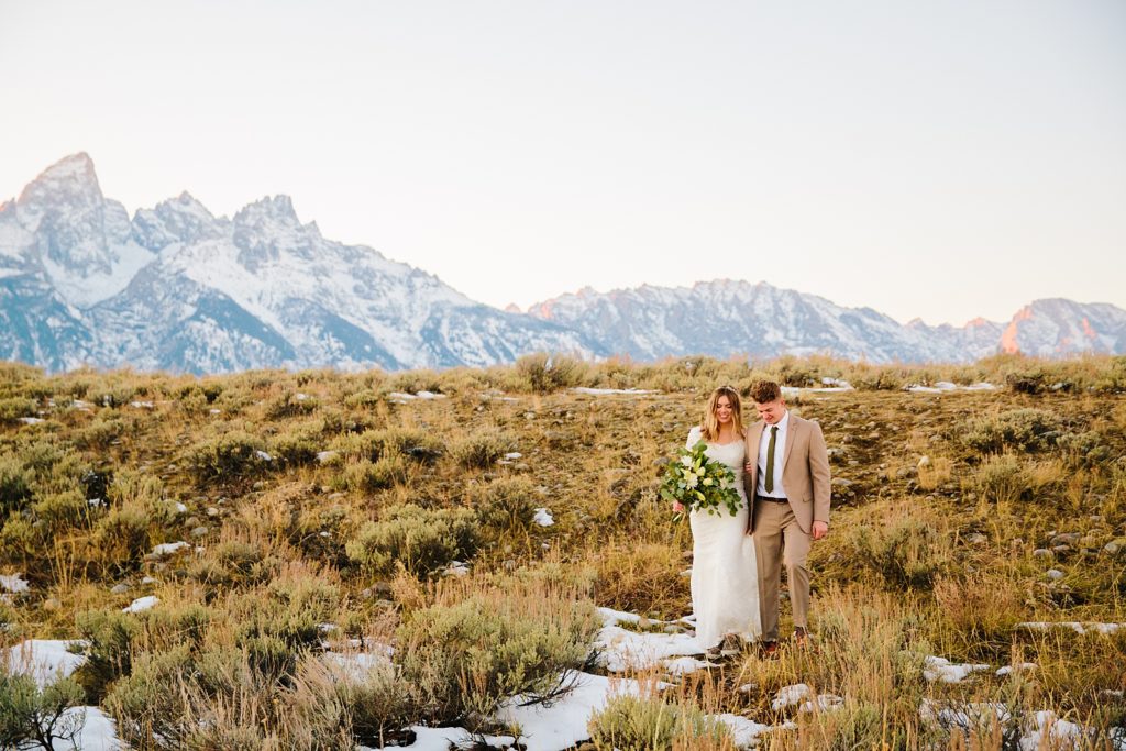 Jackson Hole wedding photographer captures couple walking through Grand Teton National Park