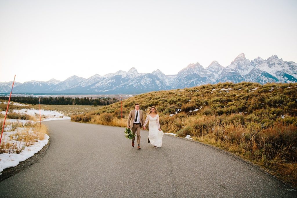 Jackson Hole wedding photographer captures bride and groom walking together through Grand Teton National Park