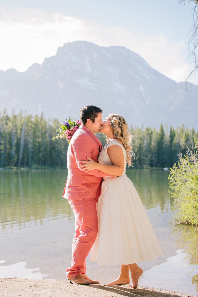 Jackson Hole wedding photographer captures Bride and groom kissing at Leigh lake elopement