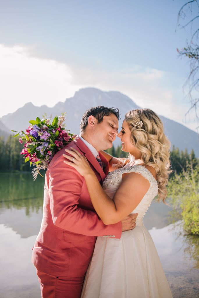 Jackson Hole wedding photographer captures bride and groom embracing during grand teton national park wedding