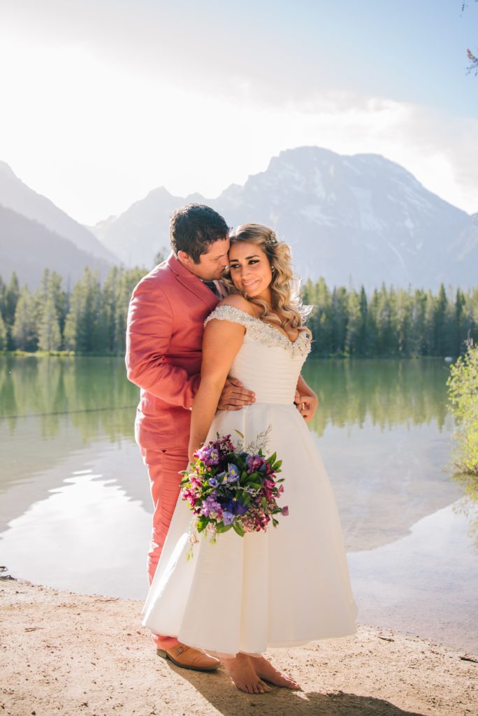 Jackson Hole wedding photographer captures bride and groom hugging during Leigh Lake Elopement