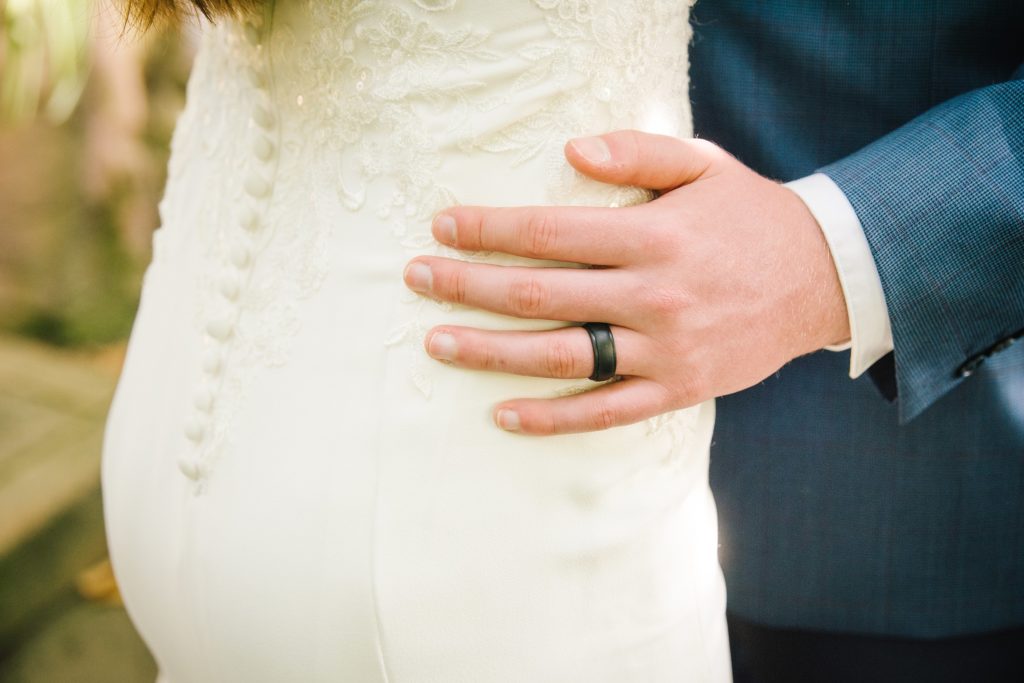 Jackson Hole wedding photographer captures grooms hands on bride
