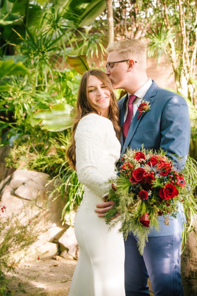 Jackson Hole wedding photographer captures Groom kissing bride 
